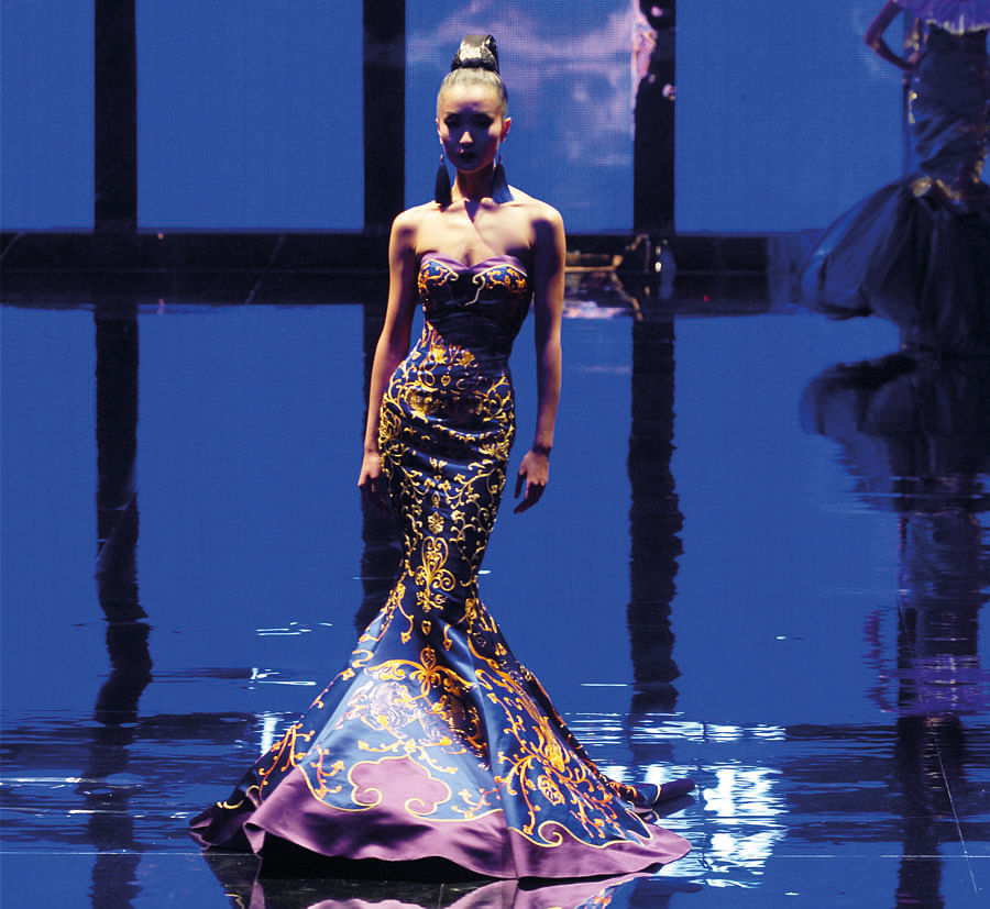 Model Du Juan in a dress by Chinese couture firm Ne-Tiger at China Fashion Week in Beijing. Chua's role is to help Chinese designers get recognised in the West, as well as promote Western luxury in China.