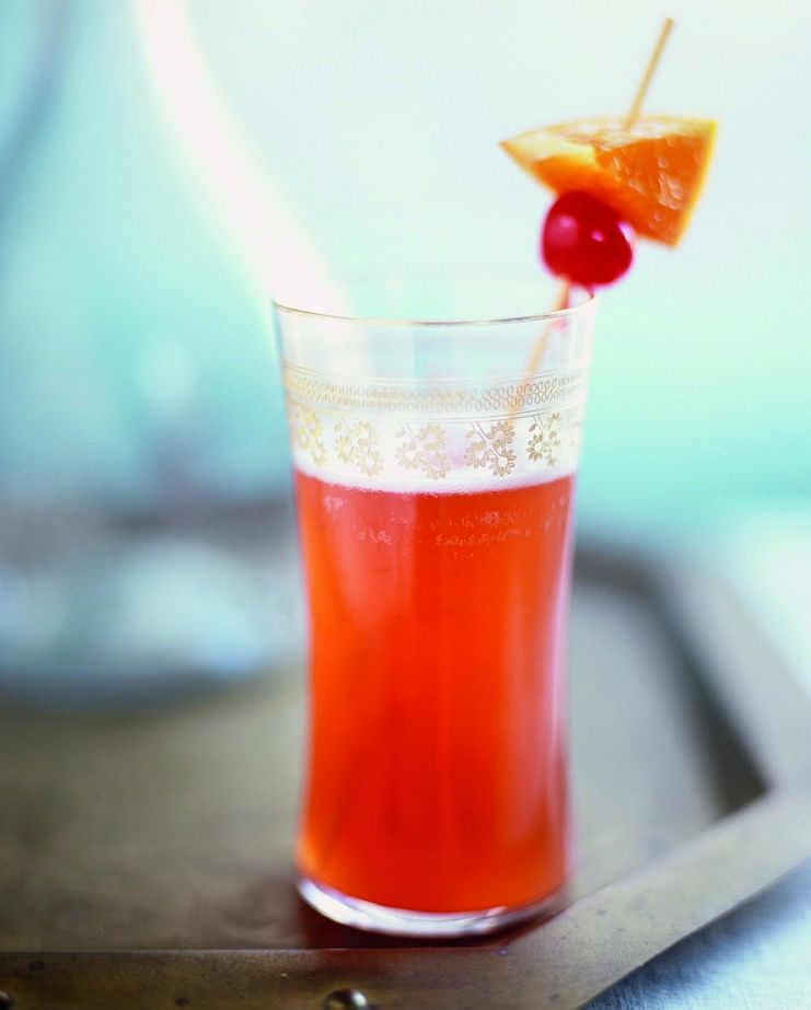 Singapore Sling made with gin, pineapple juice & cherry brandy