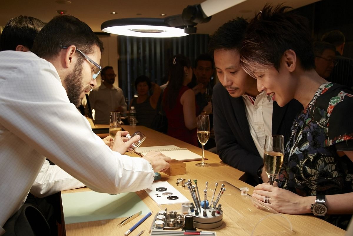 A watchmaker shares his know-how with guests at the opening party of Audemars Piguet's recently refurbished boutique at Liat Towers.