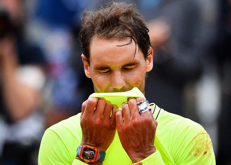 Rafael Nadal, wearing an RM 27-03 on his right wrist, celebrates his win over Dominic Thiem in last year's French Open final. (Photo by MARTIN BUREAU/AFP/Getty Images)
