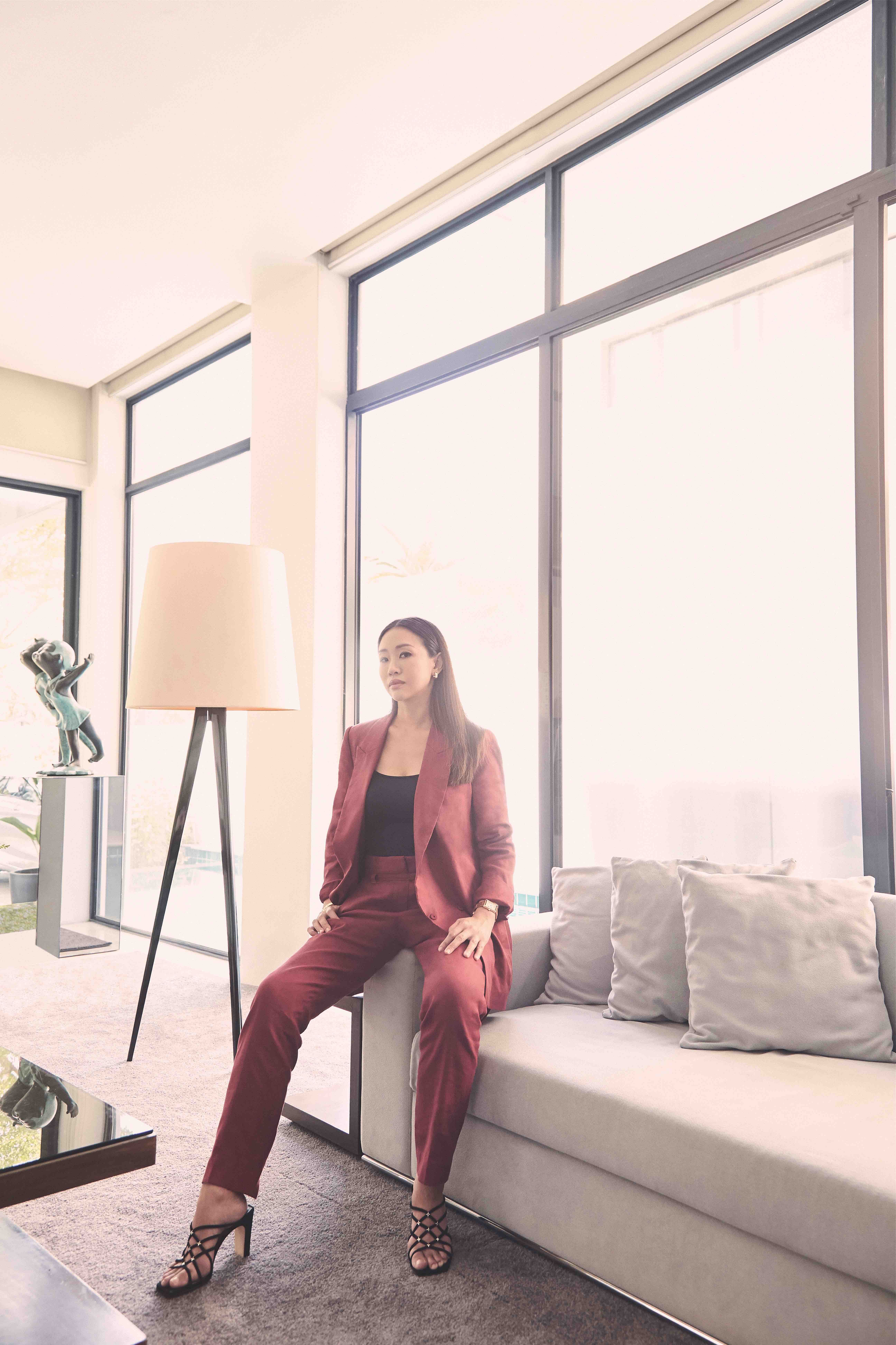 Sharon Sim is wearing a burgundy red linen pant suit from Brunello Cucinelli. All accessories and watches are from Cartier.