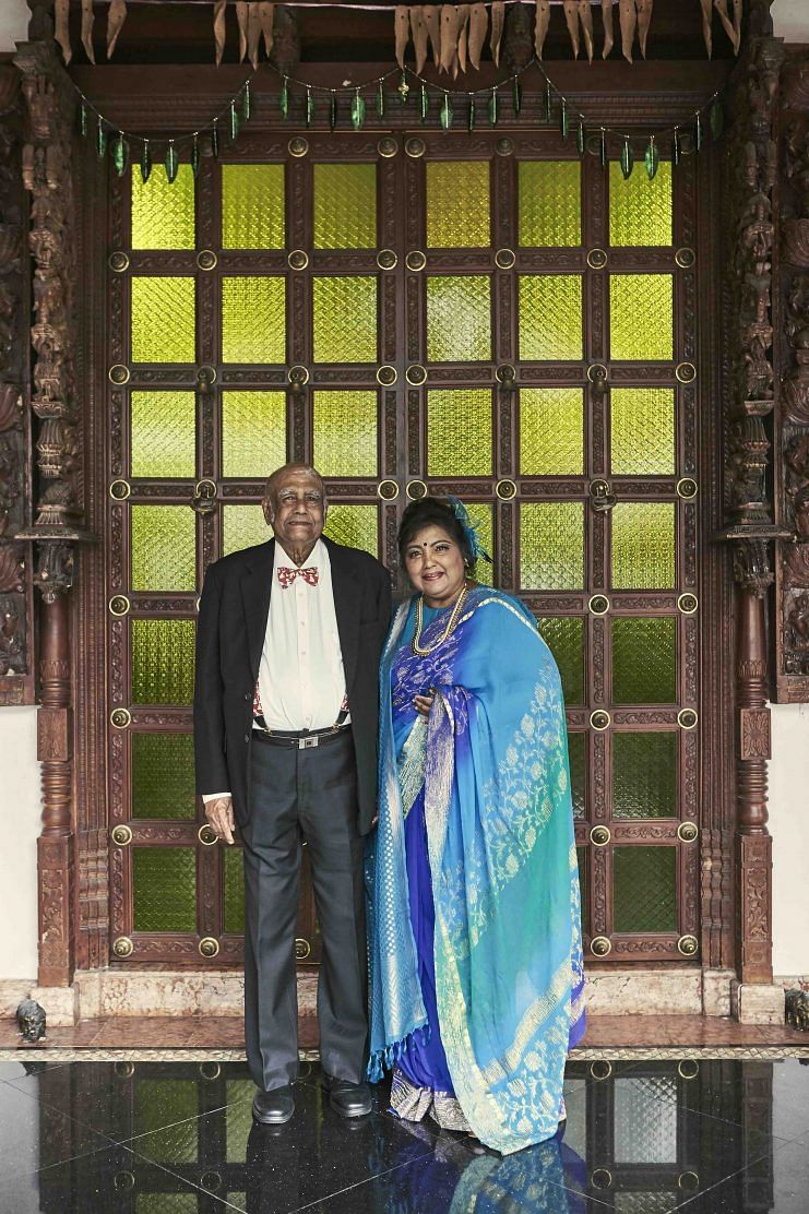Mr and Mrs Iswaran standing in front of the entrance to their home at 35 Binjai Park.