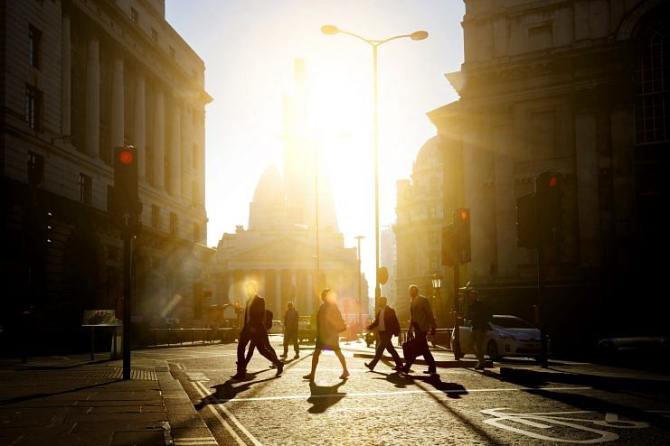 People walking to work as the sun rises. Photo credit: Getty Images