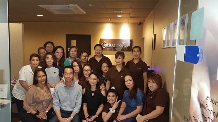 Joshua Lung (front row, in a light grey shirt) with some of his Healing Touch employees. Image credit: Joshua Lung