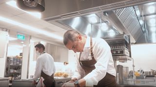 Chef Julien Royer cooking at Claudine Restaurant