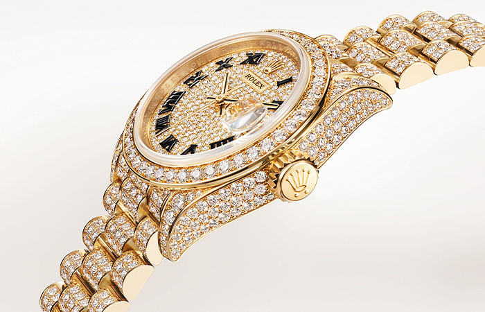Oyster Perpetual Lady- Datejust with diamond- paved dial and a diamond- set President bracelet.