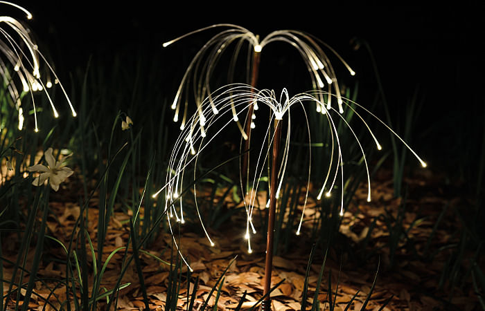 In Fireflies, copper tubes, brass stakes, optical fibre and metal halide light sources come together.