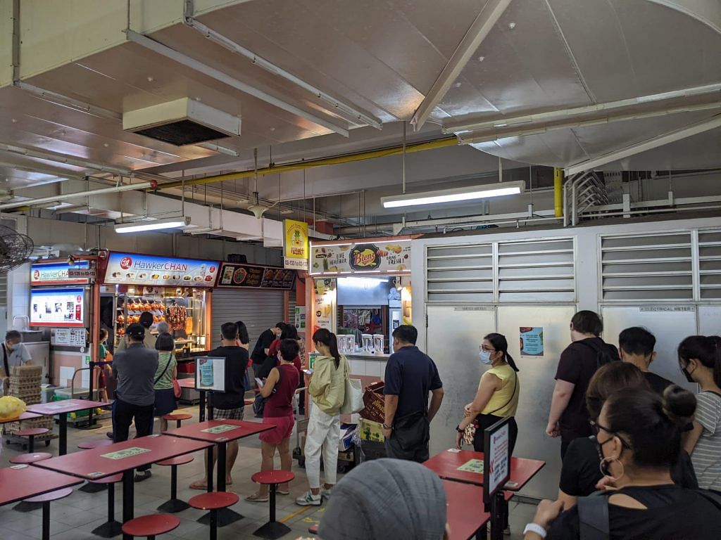 A long queue was formed at Hawker Chan barely 30 minutes after the stall opened. 