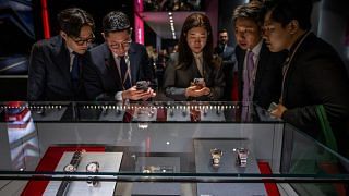 Participants gather at the booth of Swiss watchmaker Tudor on the opening day of the luxury watch fair 'Watches and Wonders Geneva', on March 27, 2023 in Geneva.