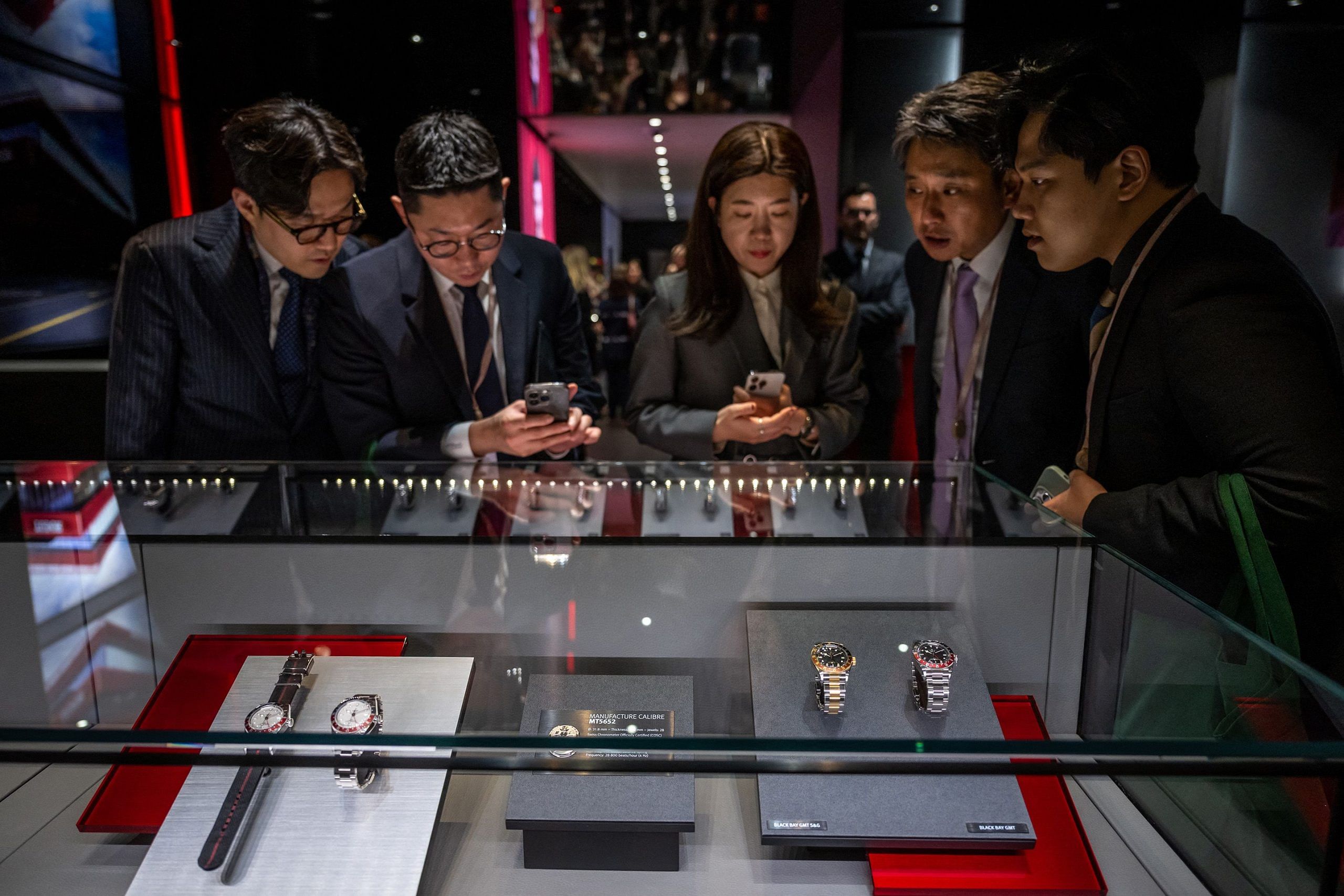 Participants gather at the booth of Swiss watchmaker Tudor on the opening day of the luxury watch fair 'Watches and Wonders Geneva', on March 27, 2023 in Geneva.