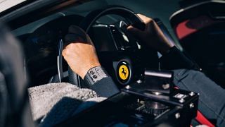 Image of a car driver wearing the Richard Mille RM UP-01 Ferrari, positioned next to a Ferrari insignia.